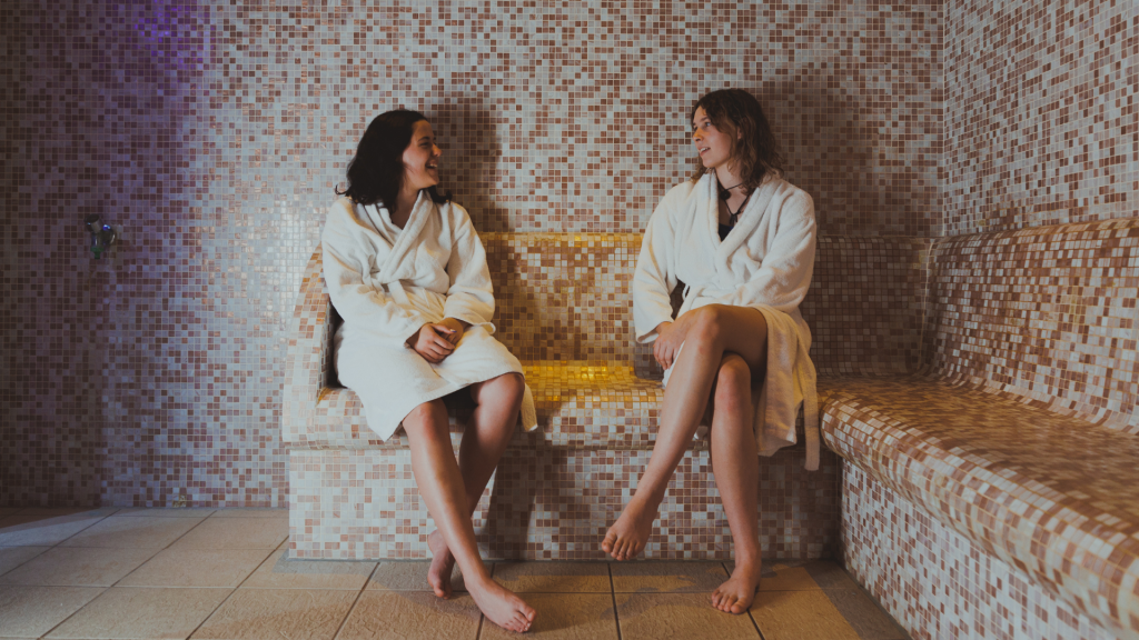 two women chatting in a spa working on their social wellness